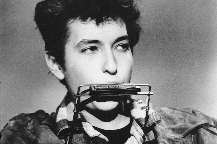 Folk singer and songwriter Bob Dylan plays the harmonica and acoustic guitar in March 1963 at an unknown location.  He was born in Duluth, Minnesota in 1941 as Robert Allen Zimmerman. (AP Photo)